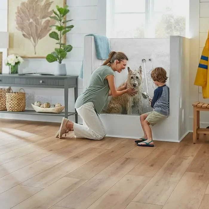 Lady and kid giving bath to dog