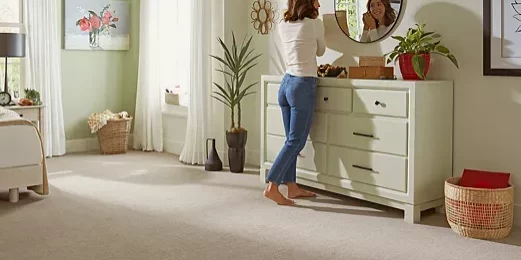 Lady wearing ear rings looking into mirror